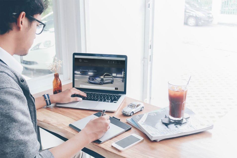 Man Working on a Macbook Pro Mockup 2 Man Working on a Macbook Pro Mockup