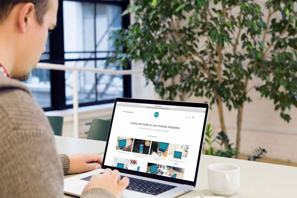 Man reading about web development on his Macbook 2 Man reading about web development on his Macbook