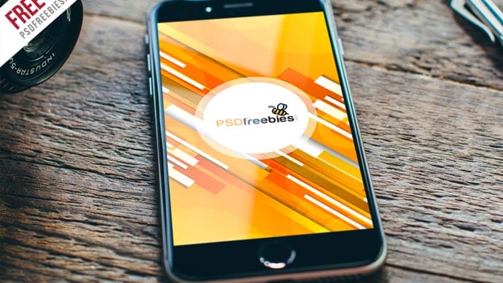 Apple iPhone on Wooden Table Mockup PSD