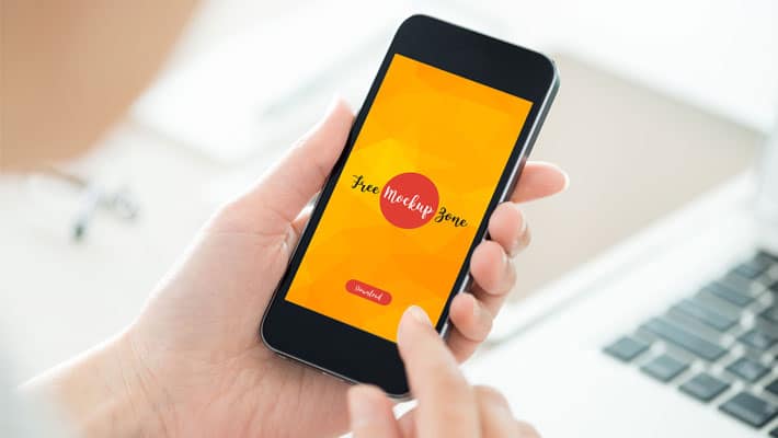 Free Person Holding Smartphone Mockup