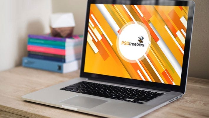 Macbook Pro on Wooden Table Mockup PSD