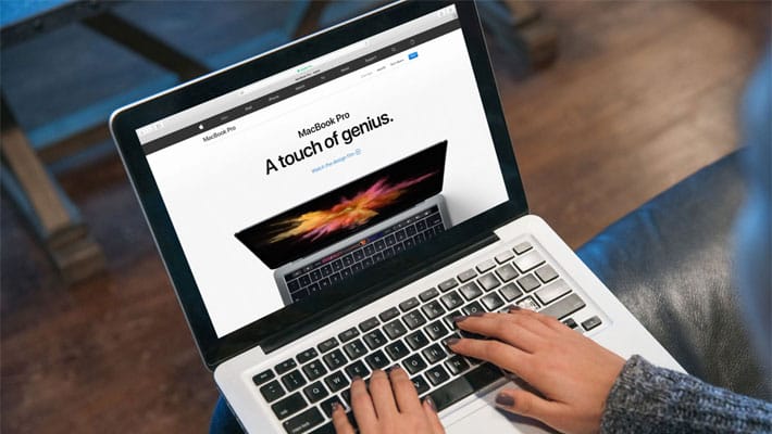Young Lady Typing Code on Macbook Pro Mockup