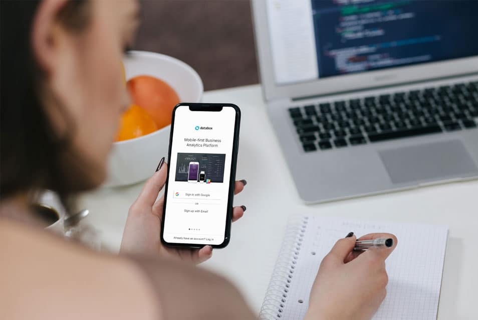 Woman Holding iPhone X and Taking Notes