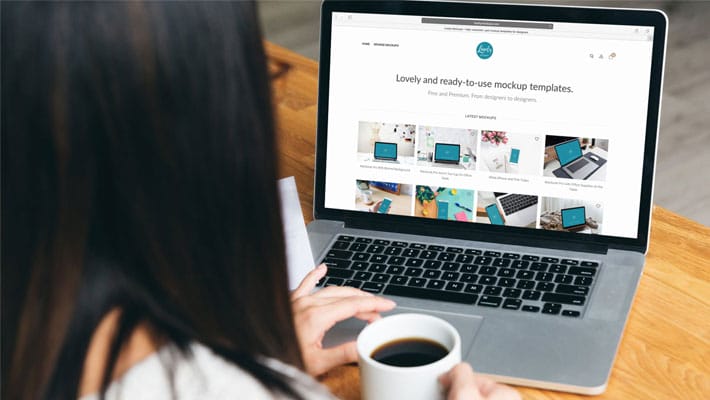 Woman Working on Her Macbook While Drinking Coffee