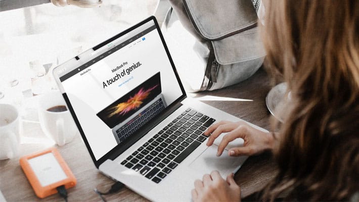 Young Woman Working On Her Macbook