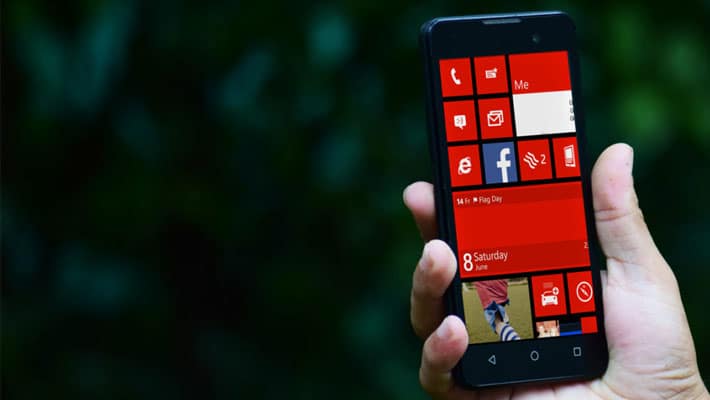 Free Hand Holding Smartphone PSD Mockup