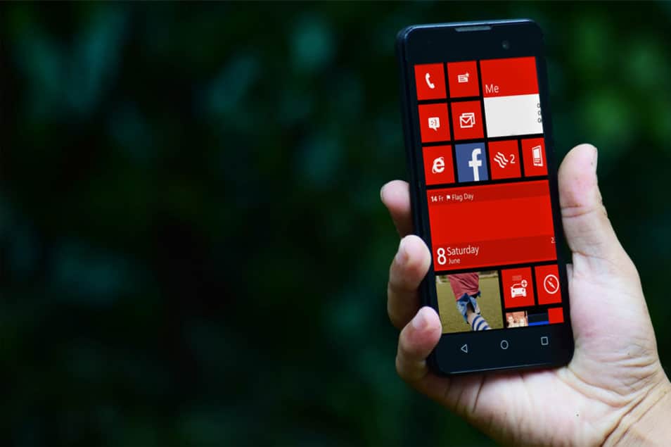 Free Hand Holding Smartphone PSD Mockup