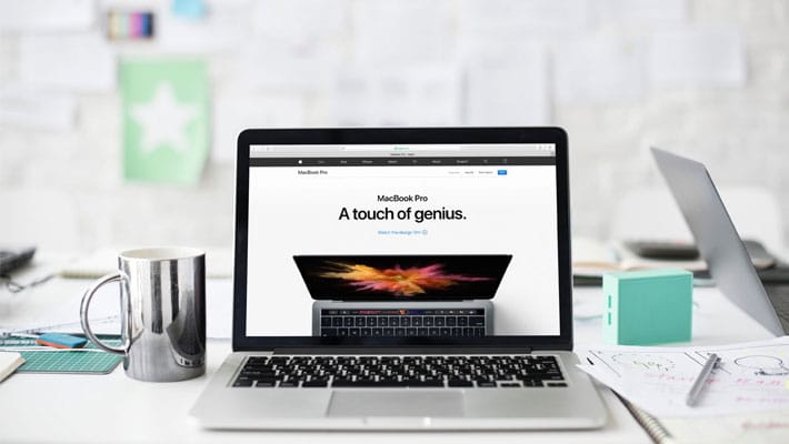 Macbook Pro And A Tea Cup On Office Desk