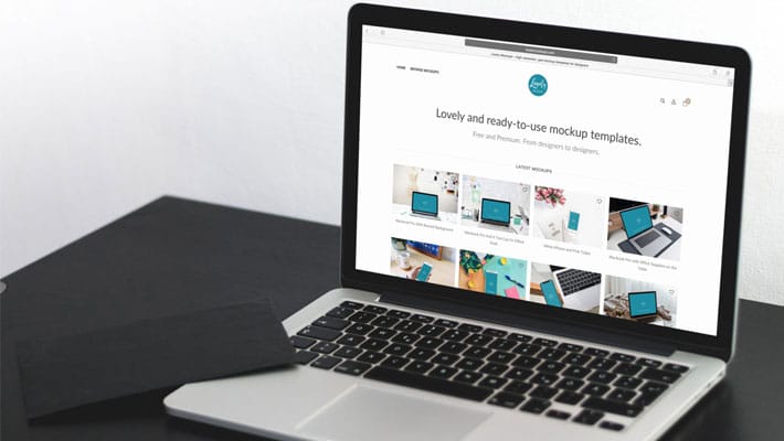 Macbook Pro On A Black Table Mockup