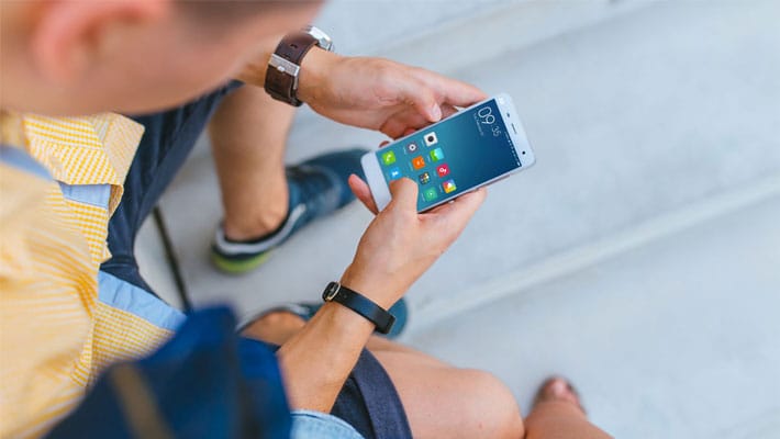 Man holding Xiaomi Mi5 in his hands