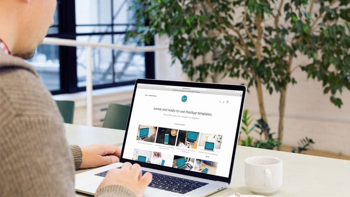 Man reading about web development on his Macbook