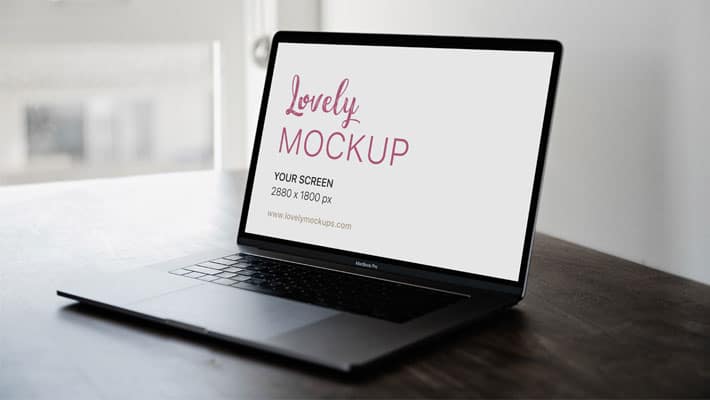 Space Grey Macbook Pro On A Brown Table