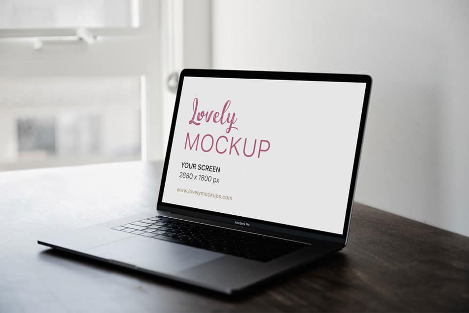 Space Grey Macbook Pro On A Brown Table