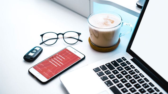 White iPhone Beside a Cappuccino and Car Keys