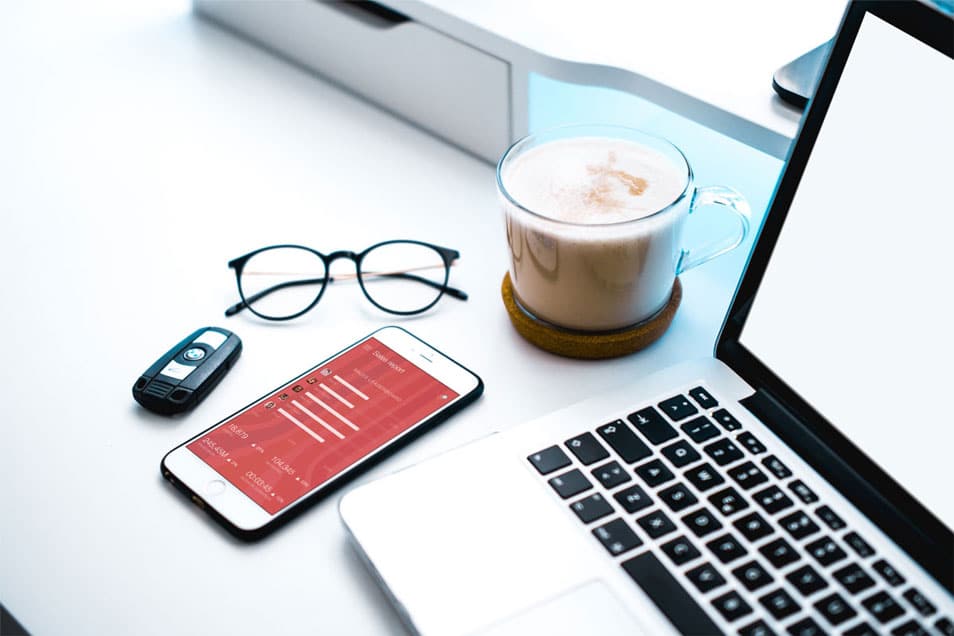 White iPhone Beside a Cappuccino and Car Keys