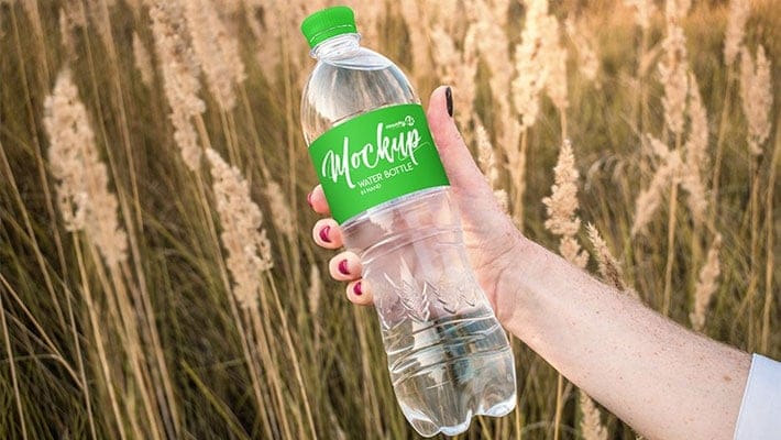Free Water Bottle in Hand PSD MockUp in 4k