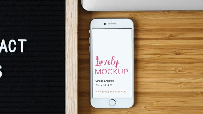 White iPhone Mockup and Contact Us Sign On Desk