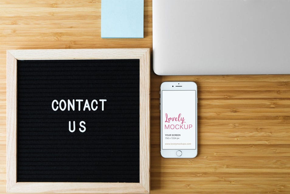 White iPhone Mockup and Contact Us Sign On Desk