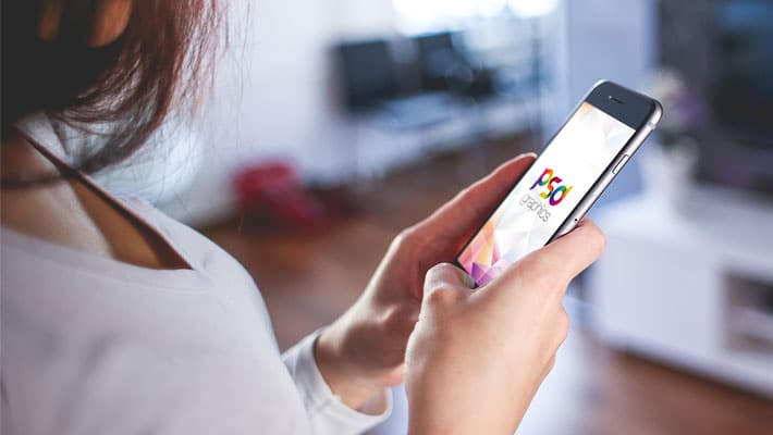 Holding iPhone in Hand Mockup PSD