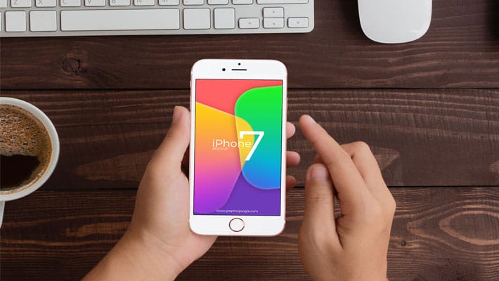 Free Man Holding iPhone 7 Mockup PSD Template