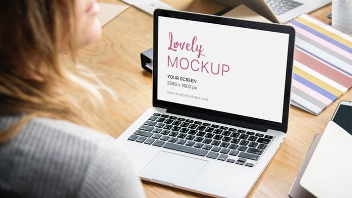 Macbook Mockup and A Young Woman Talking to Her Coworker