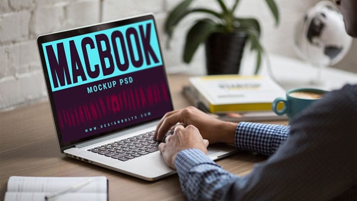 Free MacBook on Office Table Photo Mockup PSD