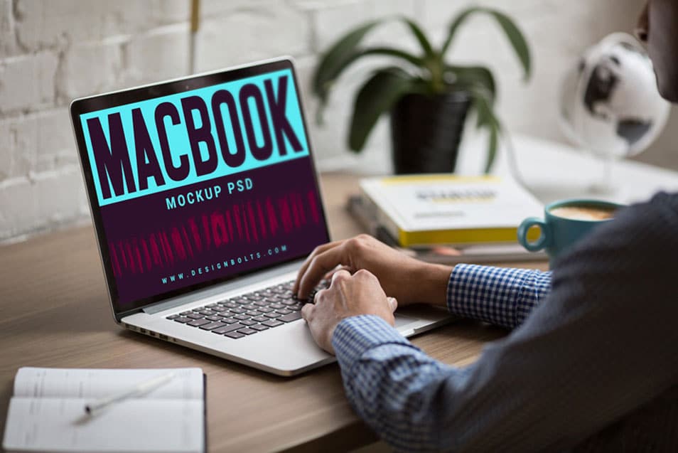 Free MacBook on Office Table Photo Mockup PSD
