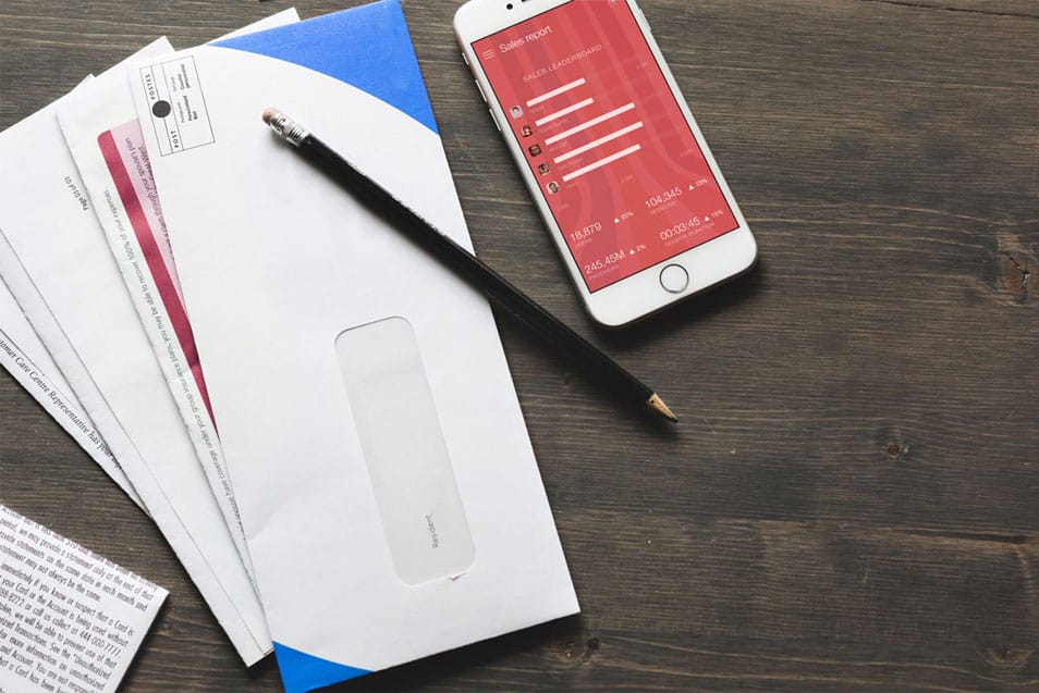 iPhone Mockup With Bills and Receipts on Table
