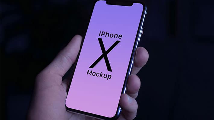 Free iPhone X in Male Hand Photo Mockup PSD