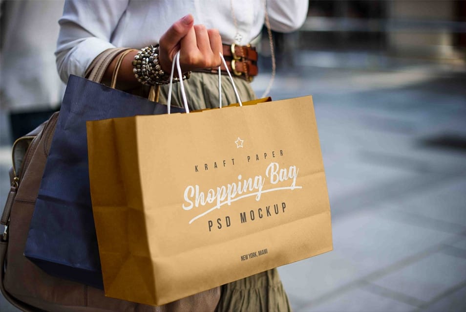 Free Female Holding Kraft Paper Shopping Bag Mockup PSD
