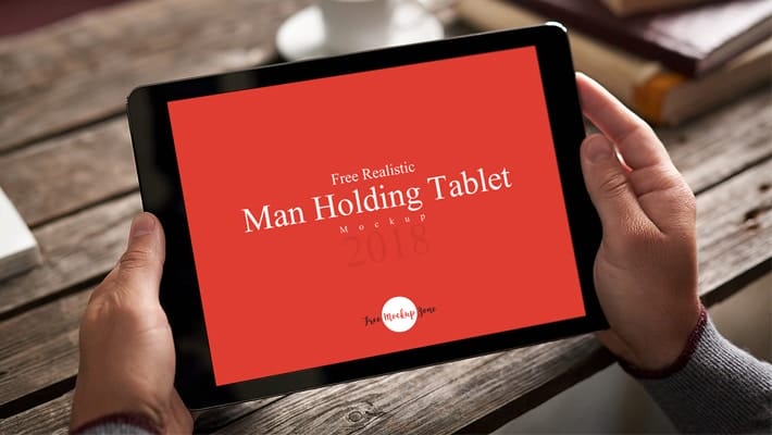Free Realistic Man Holding Tablet Mockup