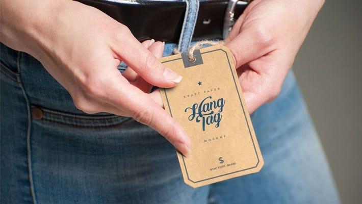Free Hand Holding Kraft Paper Hang Tag Mockup PSD