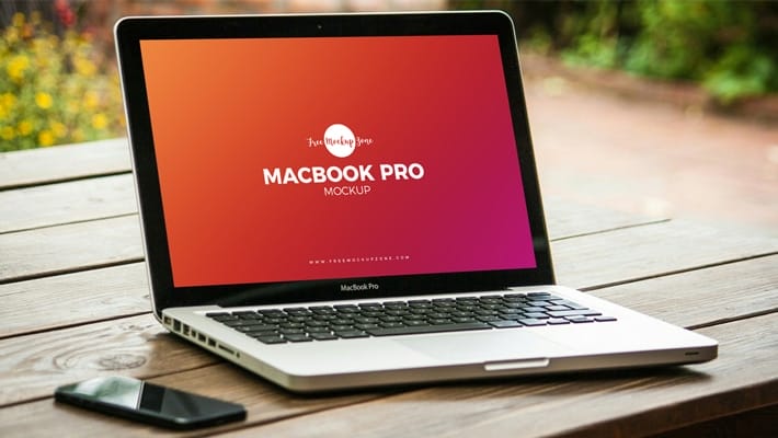 Free MacBook Pro on Wooden Table Mockup PSD