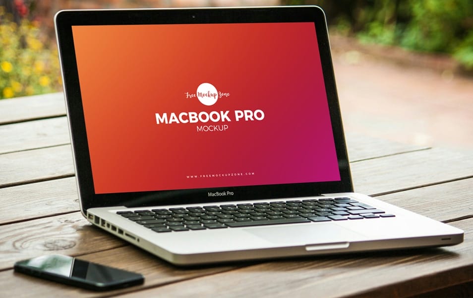 Free MacBook Pro on Wooden Table Mockup PSD