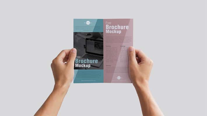 Free Man Holding Brochure in Hands Mockup PSD