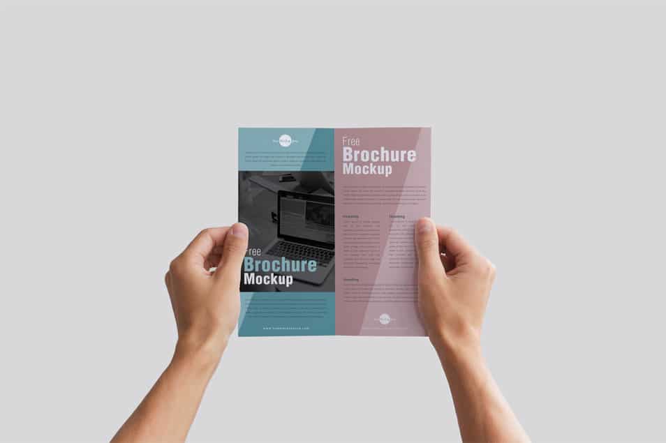 Free Man Holding Brochure in Hands Mockup PSD