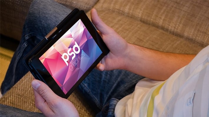 Man Holding Tablet Mockup PSD