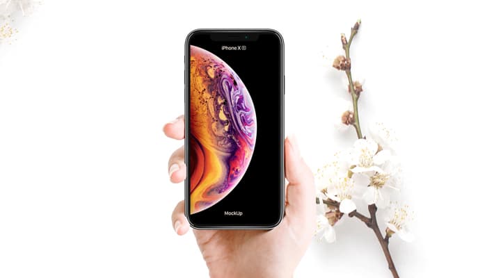 Free Woman Holding iPhone XS Mockup PSD With Flowers