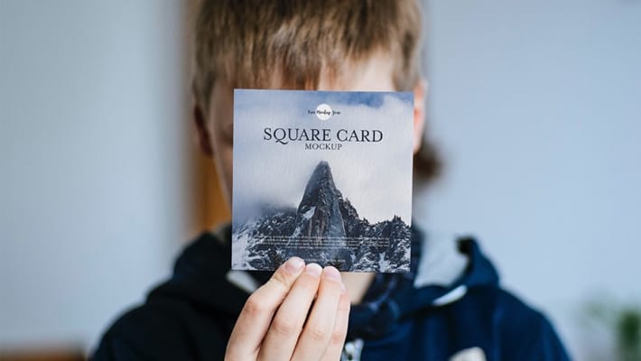 Free Little Boy Showing Square Card Mockup PSD
