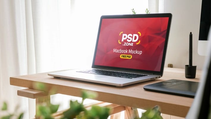 Macbook Pro on Wooden Table Mockup PSD