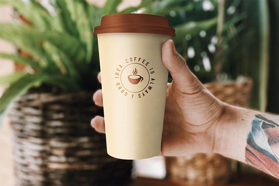 Free Hand Holding Coffee Cup Mockup PSD