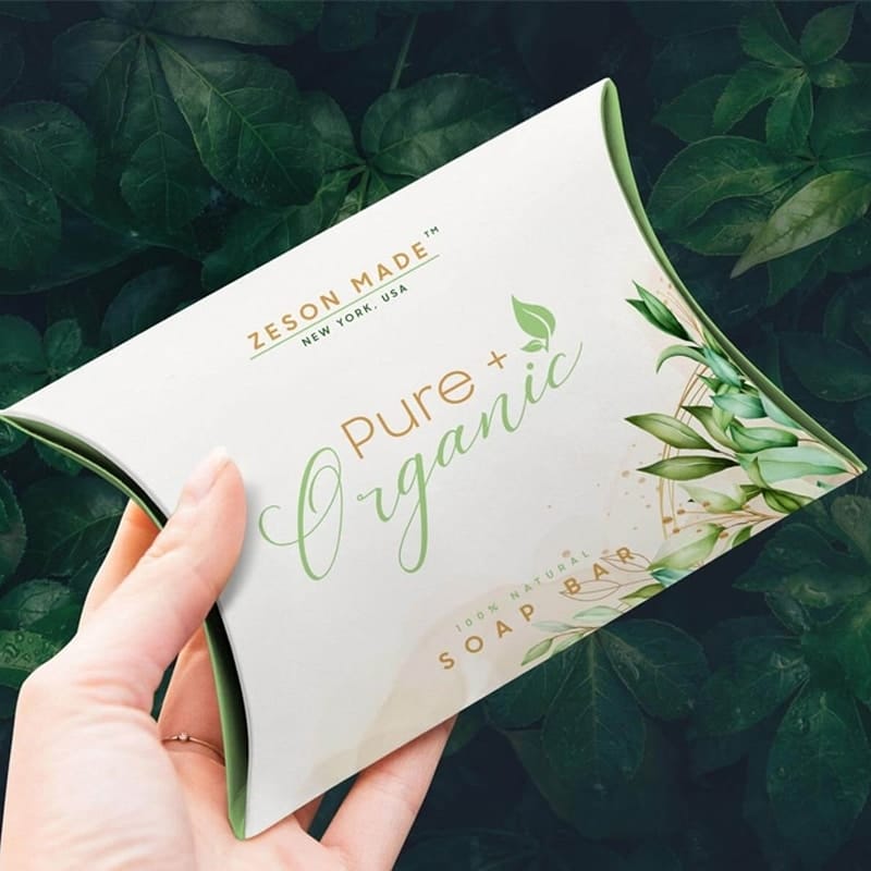 Free Hand Holding Pillow Packaging Box Mockup PSD