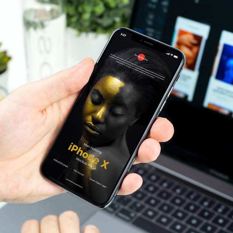 Free Man Holding iPhone X Mockup PSD