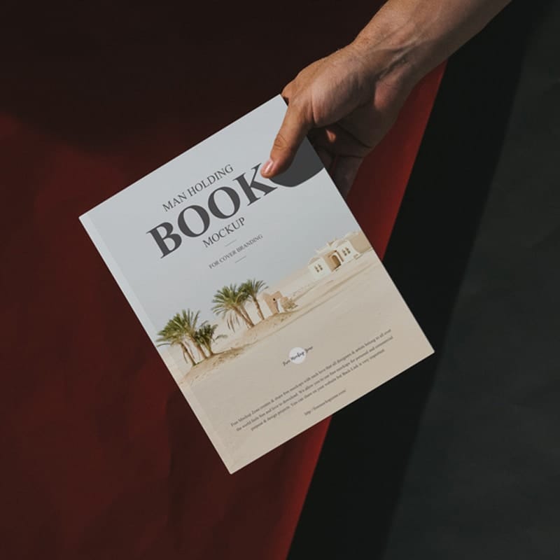 Free Man Holding Book Mockup For Cover Branding