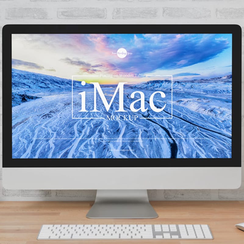 Free iMac Placing on Wooden Table Mockup