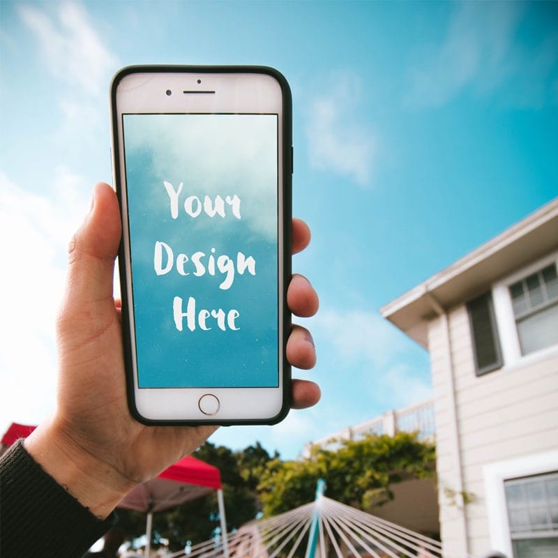 iPhone in the Hand of a Guy in a Hammock