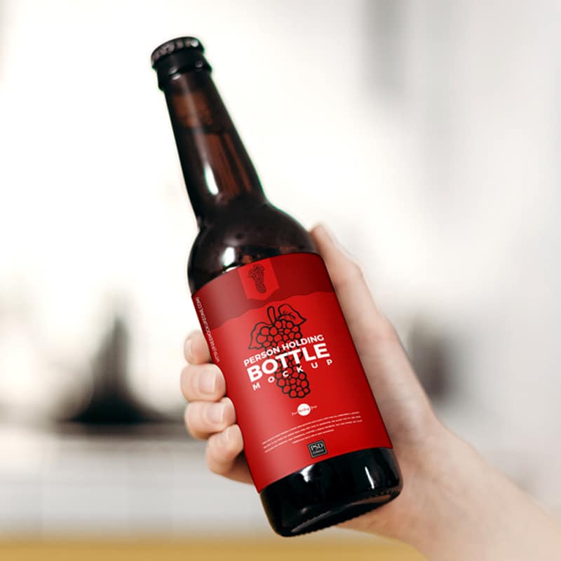 Free Person Holding Bottle Mockup