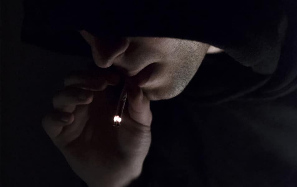 Man In Hoodie Smoking Cigarette