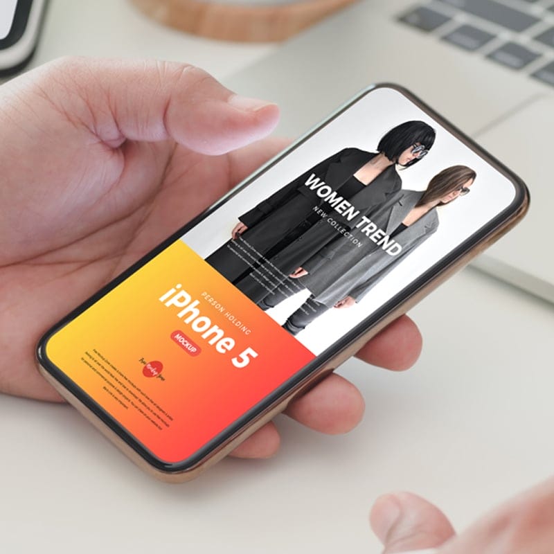 Free Person Holding iPhone 5 Mockup PSD