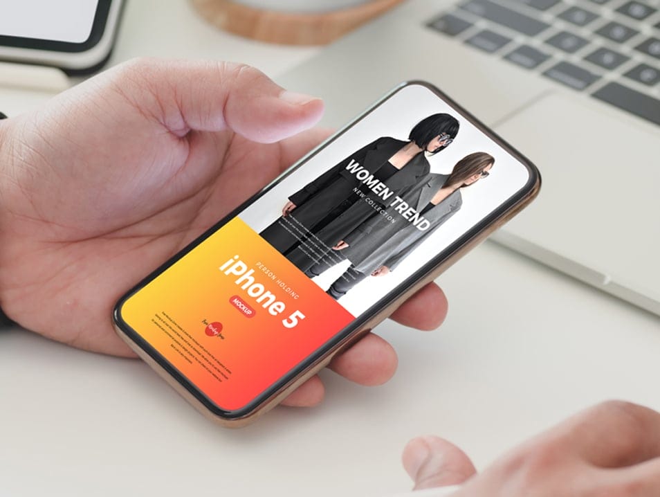 Free Person Holding iPhone 5 Mockup PSD